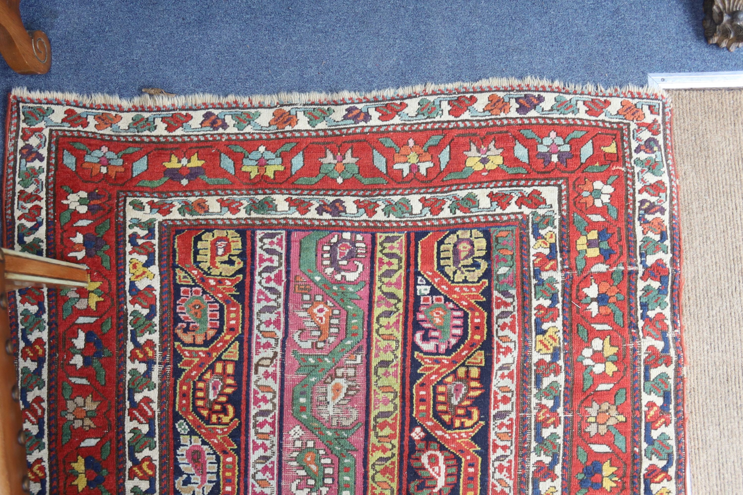 A Caucasian design Boteh red ground rug, 236 x 116cm